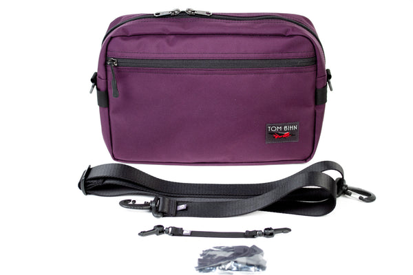 The Side Hustle and included items (1.5" shoulder strap, 8" black key strap, black cord zipper pulls).